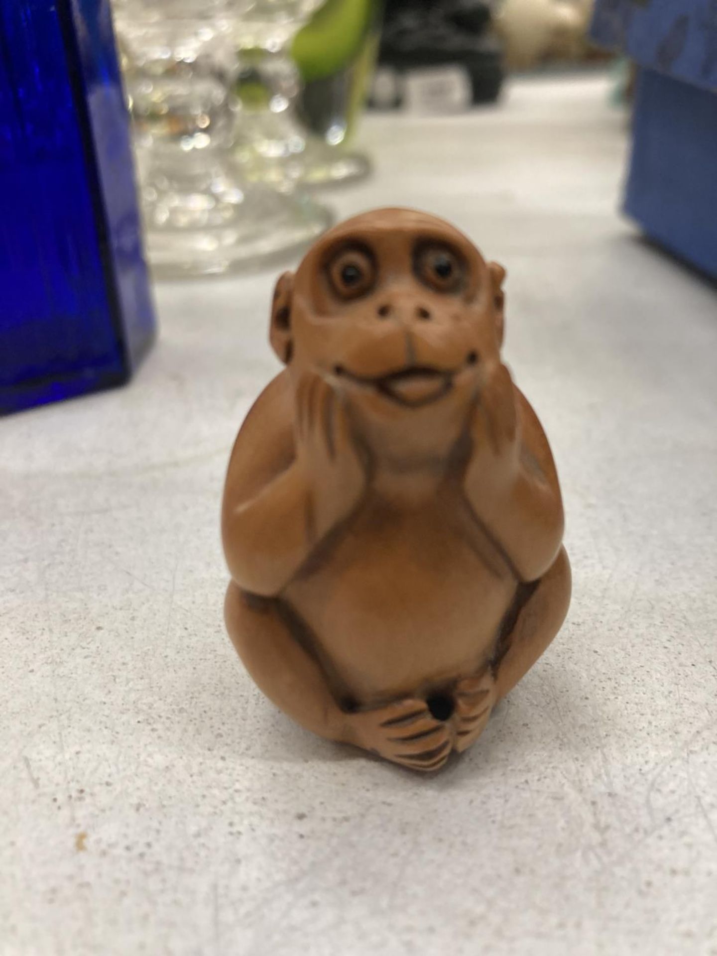 A WOODEN CARVED NETSUKE MONKEY