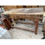 A VINTAGE WOODEN WORK BENCH WITH A WODEN WOOD VICE