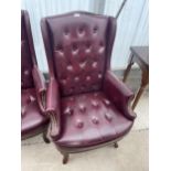 A MODERN FAUX LEATHER WINGED FIRESIDE CHAIR WITH BUTTONBACK AND STUDDING