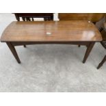 AN OAK COFFEE TABLE WITH BOW ENDS, ON TAPERED LEGS, 38X15"