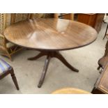 A MAHOGANY AND CROSSBANDED REGENCY STYLE EXTENDING TABLE, 48" DIAMETER (LEAF 15")