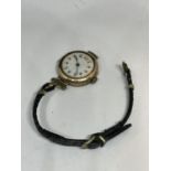 A MARKED 9 CARAT GOLD CASED WATCH WITH LEATHER STRAP IN NEED OF REPAIR