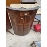 A GEORGE III MAHOGANY AND INLAID BOWFRONTED CORNER CUPBOARD