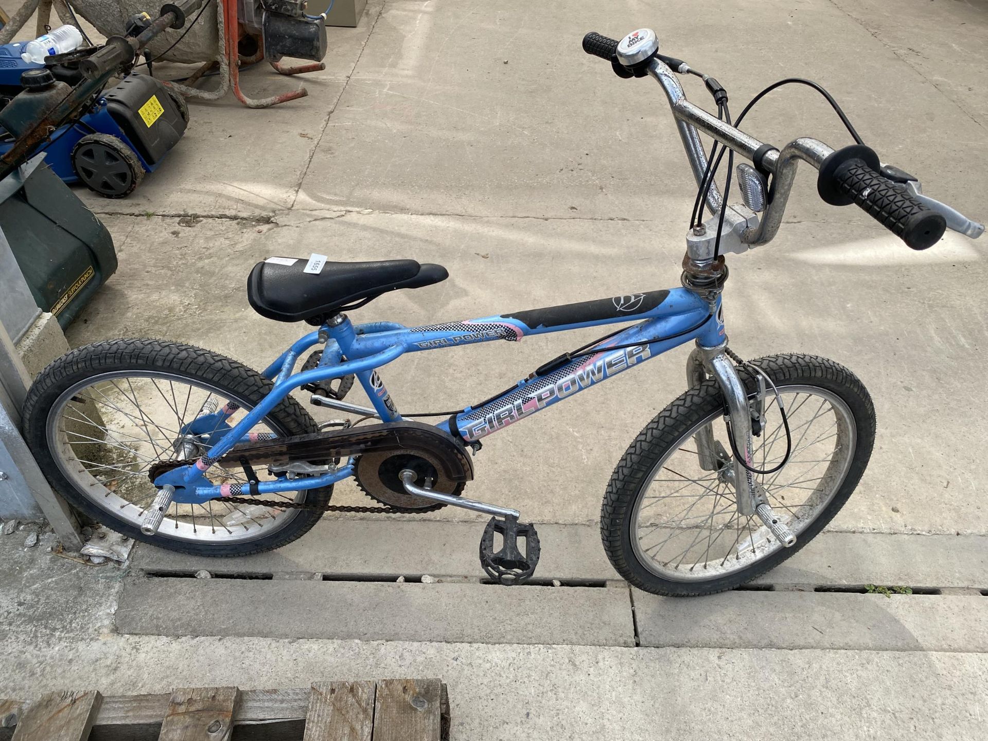 A GIRL POWER STUNT BIKE WITH FRONT AND REAR PEGS