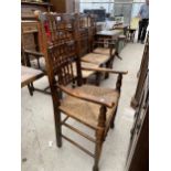 FOUR LANCASHIRE STYLE SPINDLE BACK DINING CHAIRS WITH RUSH SEATS, TWO BEING CARVERS