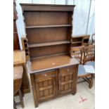 A REPRODUCTION OAK DRESSER COMPLETE WITH PLATE RACK, 36" WIDE