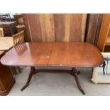 A REGENCY STYLE MAHOGANY AND CROSSBANDED TWIN-PEDESTAL DINING TABLE