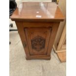 A LATE VICTORIAN WALNUT POT CUPBOARD WITH VASE AND FLOWER CARVING TO THE DOOR, 16" WIDE