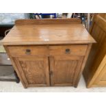 AN EARLY 20TH CENTURY OAK SIDE-CABINET WITH TWO DRAWERS AND TWO CUPBOARDS 36" WIDE