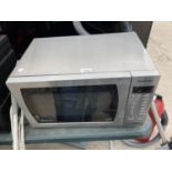 A SILVER PANASONIC MICROWAVE OVEN