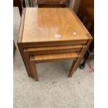 A RETRO TEAK NEST OF THREE TABLES