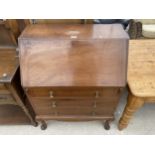 AN EDWARDIAN MAHOGANY BUREAU WITH THREE DRAWERS ON CABRIOLE LEGS, 30" WIDE