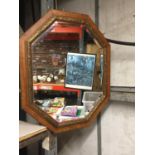 A WOODEN FRAMED OCTAGONAL BEVELLED MIRROR 79CM X 64CM