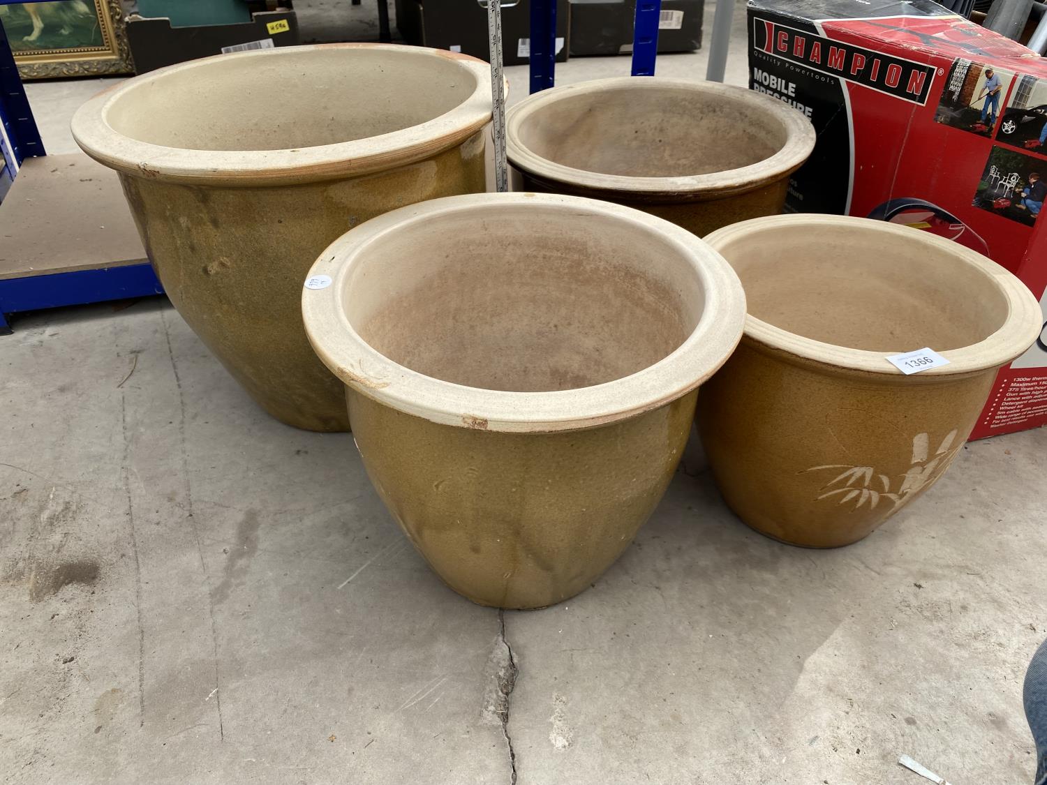 A SET OF FOUR GRADUATED GLAZED PLANT POTS