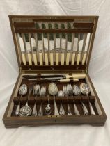 AN OAK CASED FORTY SEVEN PIECE CANTEEN OF CUTLERY WITH BONE HANDLED KNIVES