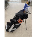 A MIZUNO GOLF BAG AND AN ASSORTMENT OF GOLF CLUBS