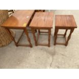 A NEST OF THREE OAK TABLES