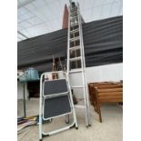 A YOUNGMAN 100 22 RUNG EXTENDABLE LADDER AND A SMALL STEP LADDER