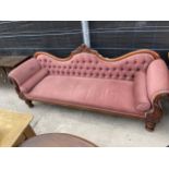 A VICTORIAN MAHOGANY SCROLL-END COUCH WITH BUTTON-BACK, ON TURNED LEGS