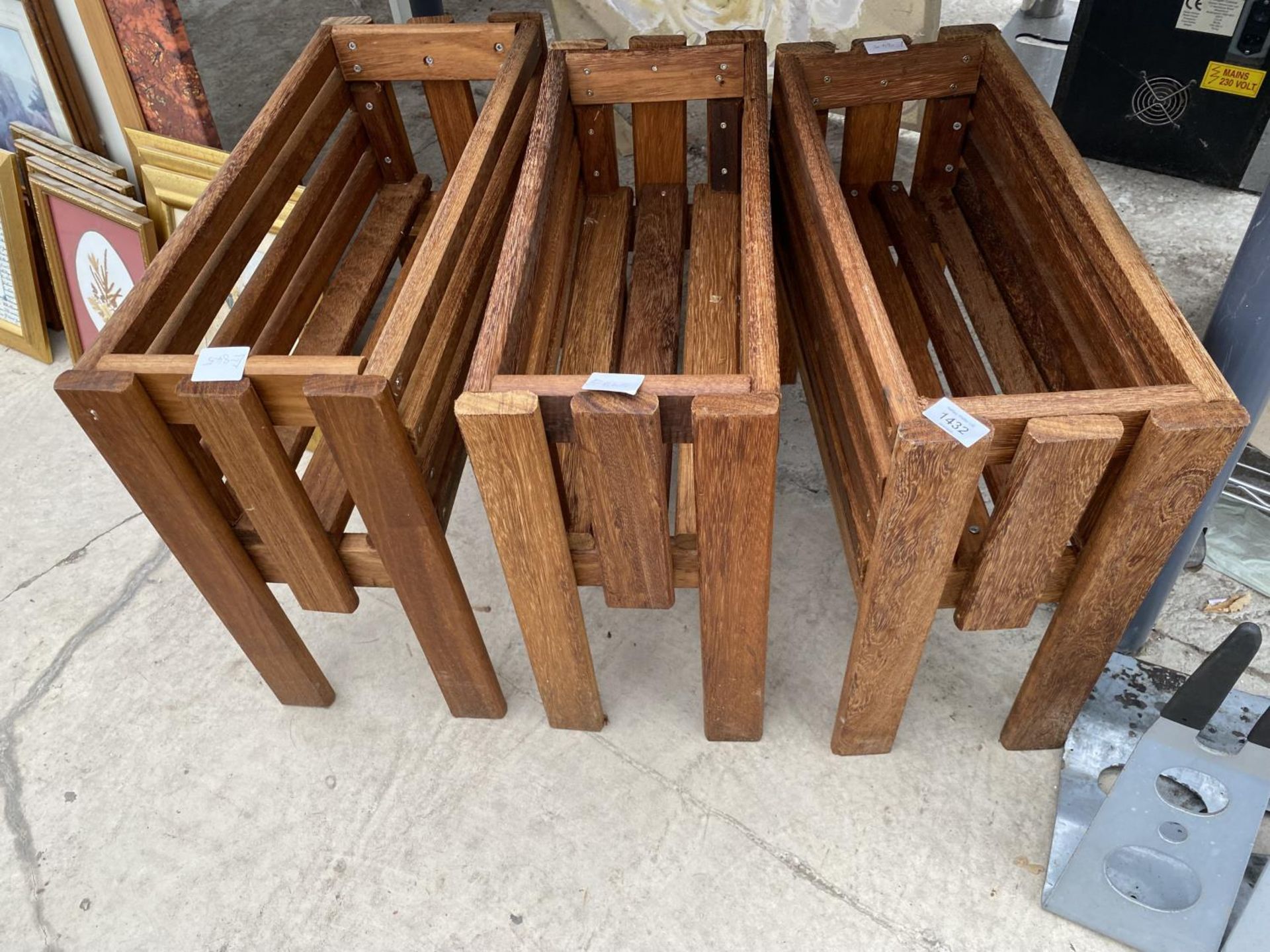 A SET OF THREE WOODEN TROUGH PLANTER HOLDERS