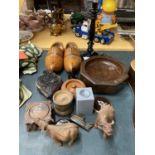 A QUANTITY OF TREEN ITEMS TO INCLUDE A PRINTING BLOCK, CLOGS, CARVED BUFFALOES, TABLE LAMP, BOWLS,