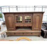 A LARGE CONTINENTAL STYLE OAK CABINET ENCLOSING SIX DRAWERS, FOUR CUPBOARDS (TWO BEING GLAZED AND