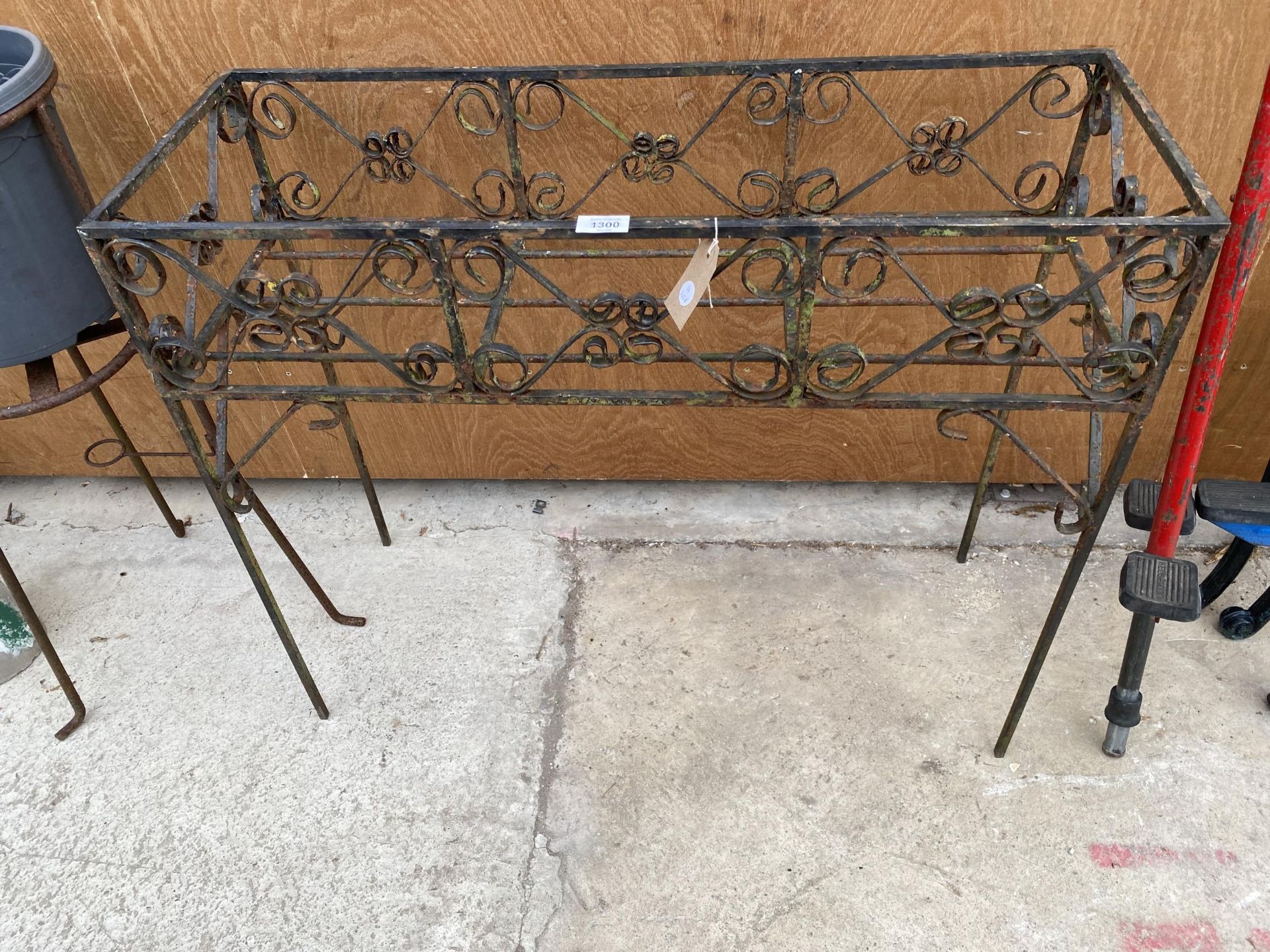 A DECORATIVE WROUGHT IRON PLANT STAND