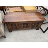 AN OAK OLD CHARM BLANKET CHEST WITH LIFT-UP LID AND PULL-DOWN FRONT SECTION WITH CARVED PANELS