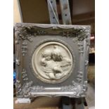 A STONEWARE PLAQUE OF CLASSICAL CHILDREN IN A SILVER COLOURED FRAME 30CM X 30CM