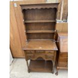 A MINIATURE OAK DRESSER ENCLOSING FIVE DRAWERS, POT BOARD AND PLATE RACK BEARING REPRODUX, BEVAN