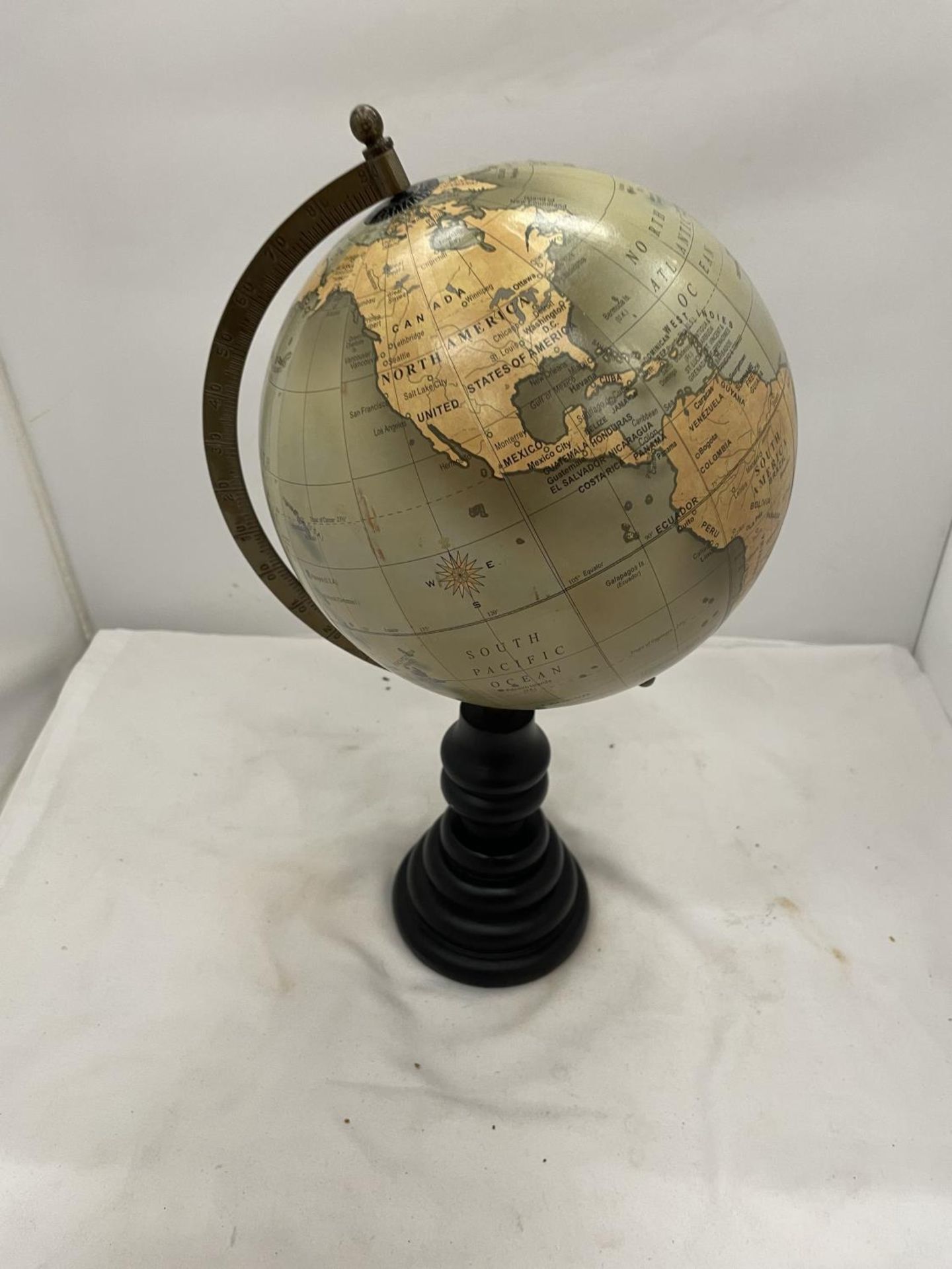 A WORLD GLOBE ON A WOODEN STAND HEIGHT 40CM