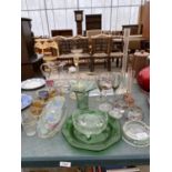 A LARGE ASSORTMENT OF GLASS WARE TO INCLUDE A WOODBINES ASH TRAY, VASES AND COLOURED GLASSES ETC