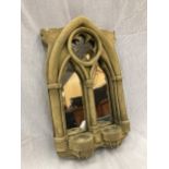 A STONE FRAMED GOTHIC WINDOW STYLE MIRROR