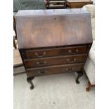 A REPRODUCTION MAHOGANY BUREAU ON CABRIOLE LEGS, 29.5" WIDE