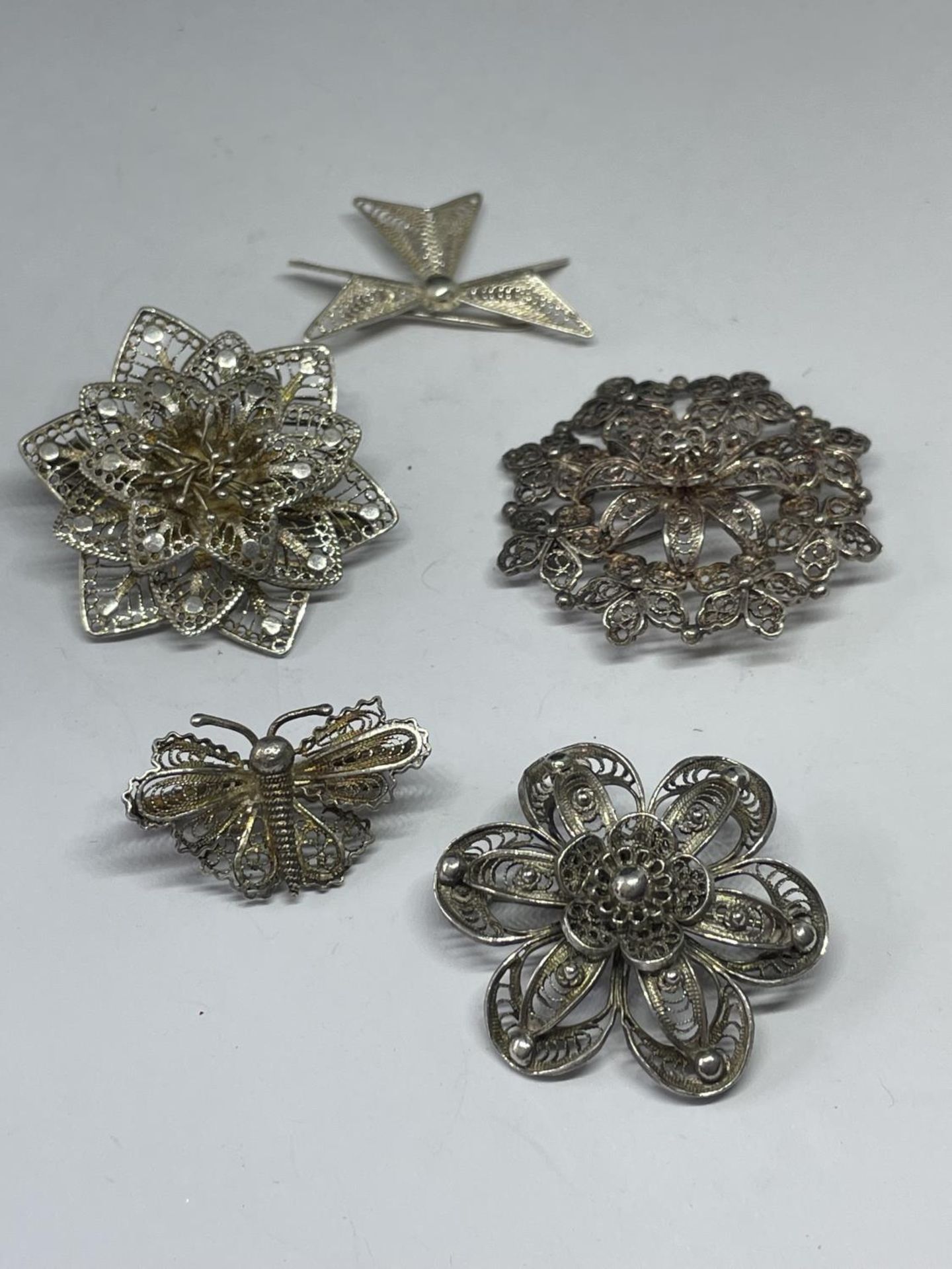 FIVE DECORATIVE SILVER BROOCHES