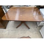 A REGENCY MAHOGANY TILT TOP DINING TABLE, 54X41" ON QUATREFOIL BASE WITH BRASS TERMINALS AND CASTERS