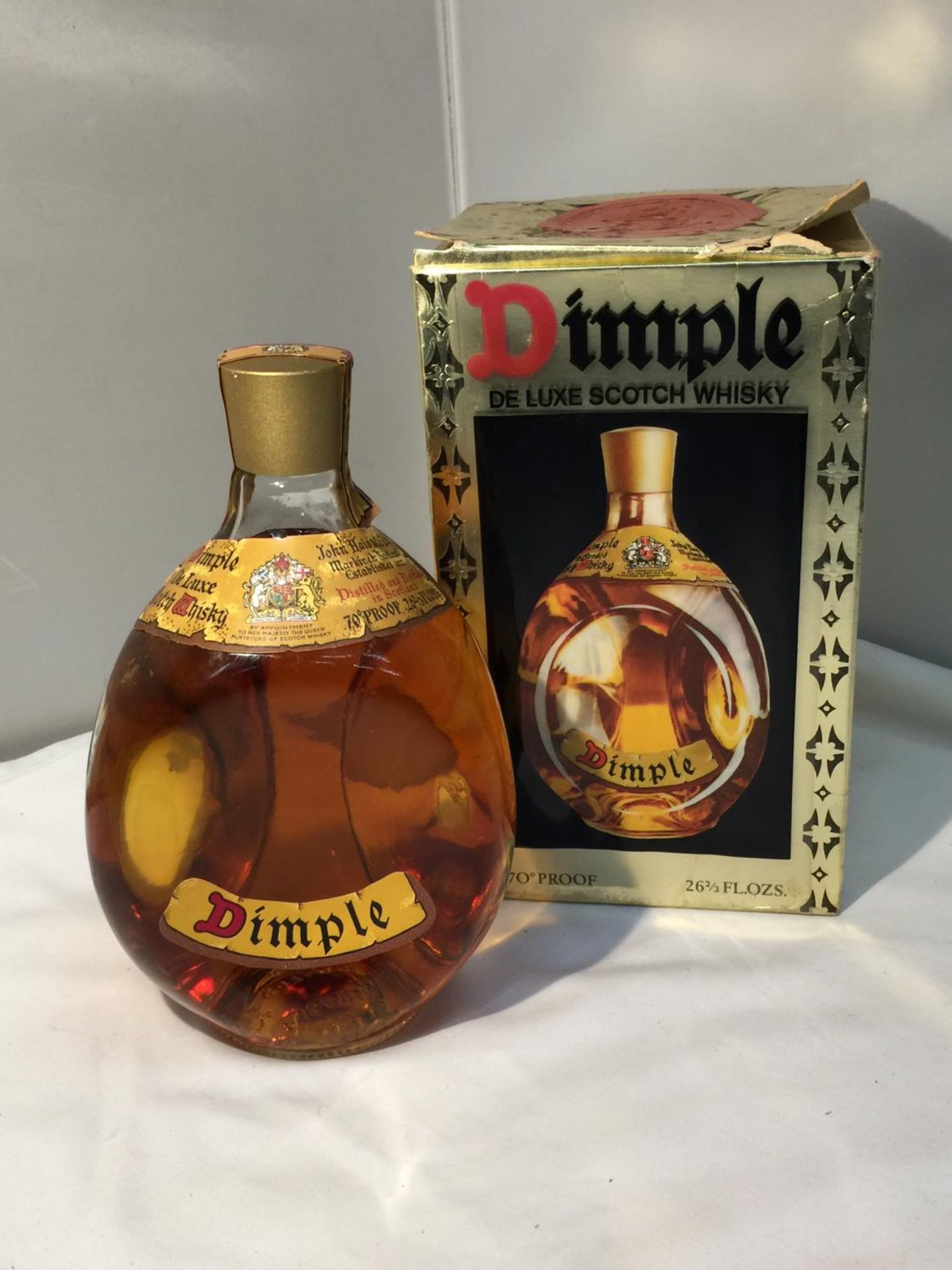 A BOXED DIMPLE DE LUXE SCOTCH WHISKY 70 PROOF 26 2/3 FL.OZS. PROCEEDS TO BE DONATED TO EAST CHESHIRE