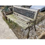 A WOODEN BENCH WITH CAST IRON ENDS AND BACK