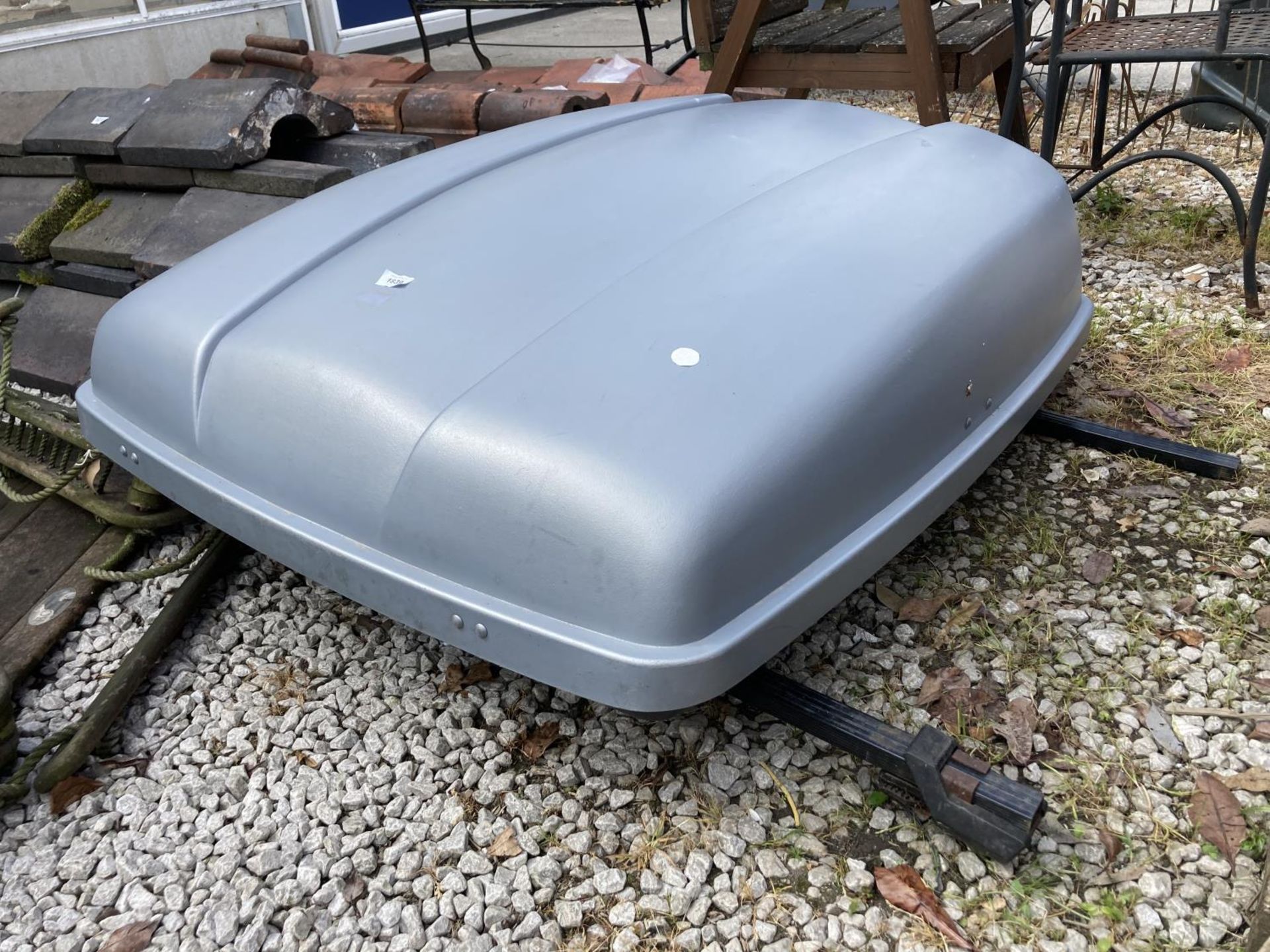 A CAR ROOF BOX WITH ROOF BARS