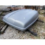 A CAR ROOF BOX WITH ROOF BARS