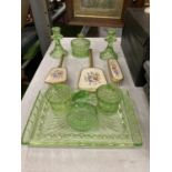 A GREEN GLASS DRESSING TABLE SET TO INCLUDE TRAY, CANDLESTICKS, POTS AND JARS, ETC PLUS AN
