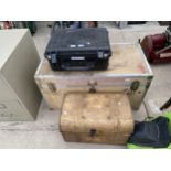 A WOODEN TRUNK CONTAINING WHEELS ETC, A TIN CHEST AND A NOISE SYSTEM KIT CASE