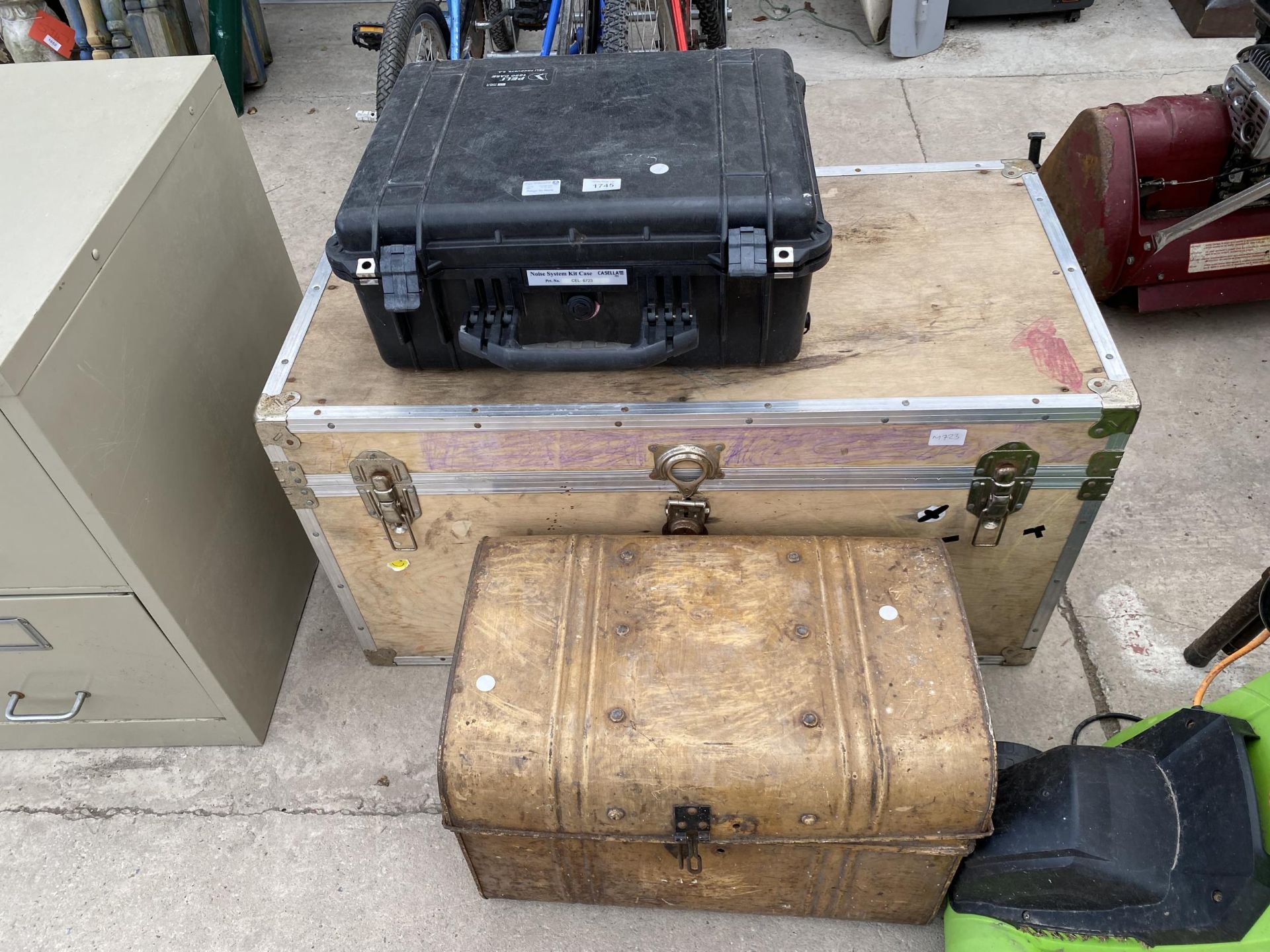 A WOODEN TRUNK CONTAINING WHEELS ETC, A TIN CHEST AND A NOISE SYSTEM KIT CASE