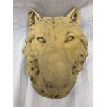A STONE BUST OF A WOLF HEAD