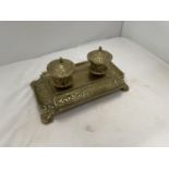 AN ELABORATELY DECORATED BRASS INKWELL