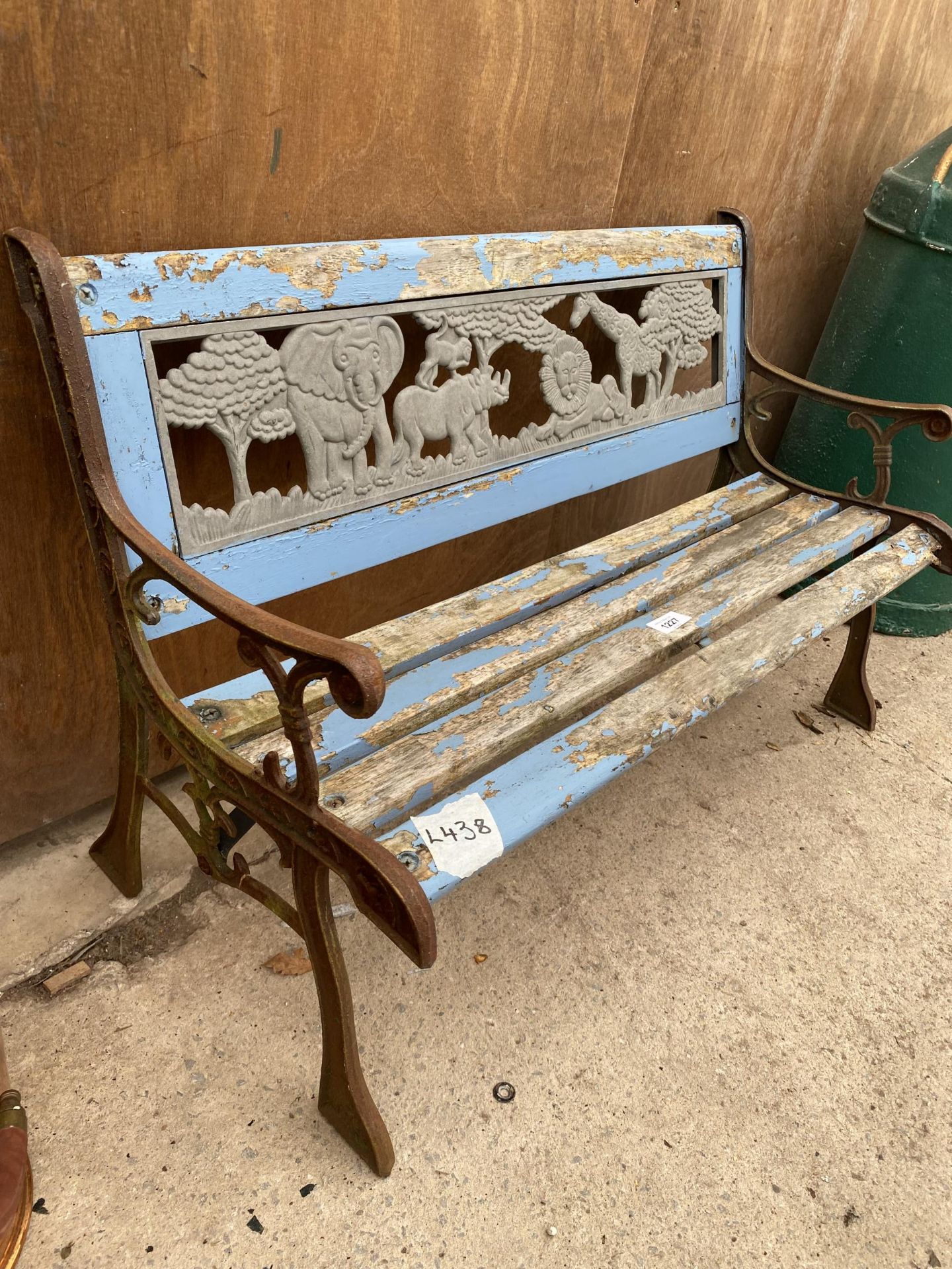 A SMALL WOODEN SLATTED CHILDRENS BENCH WITH CAST ENDS AND PLASTIC SAFARI BACK - Image 3 of 4