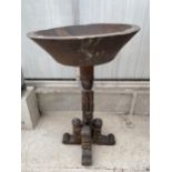 AN AFRICAN HARDWOOD FONT, 18" DIA ON CARVED COLUMN AND BASE