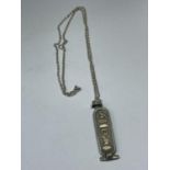 A SILVER AND GOLD INGOT ON A CHAIN WITH A PRESENTATION BOX