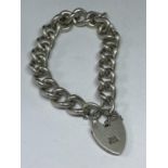 A HEAVY MARKED SILVER BRACELET WITH HALLMARKED BIRMINGHAM SILVER HEART LOCJ