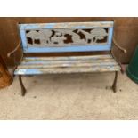 A SMALL WOODEN SLATTED CHILDRENS BENCH WITH CAST ENDS AND PLASTIC SAFARI BACK